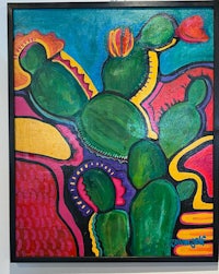 a painting of a cactus on a wall