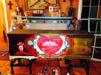 a painting of frida kahlo on a chest of drawers